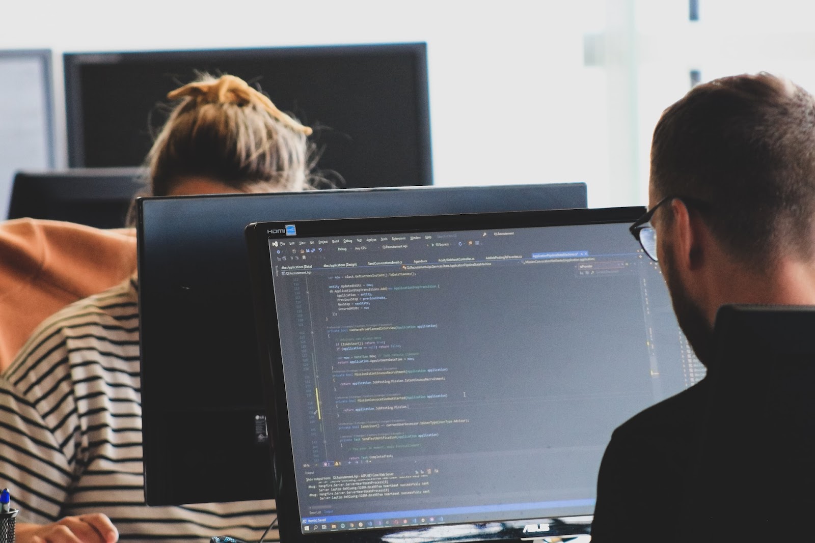 Man working on code on a computer