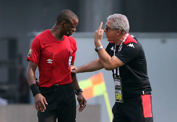 Tunisia coach Mondher Kebaier remonstrates with controversial referee Janny Sikazwe in the match where he blew the whistle before regulation time.