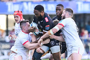 Sharks captain Lukhanyo Am challenged by Ulster players during their United Rugby Championship match at Hollywoodbets Kings Park Stadium.