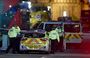 Police officers work at the scene after an attack on Westminster Bridge in London, Britain. REUTERS/Hannah McKay