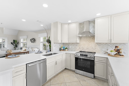 Modern white kitchen with island in this luxury apartment / penthouse for sale in St. Augustine ($899,000)