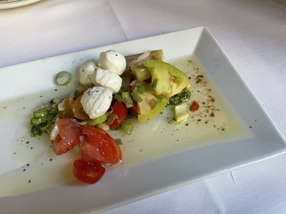 Mozzarella with tomato, pesto & vinaigrette appetizer.