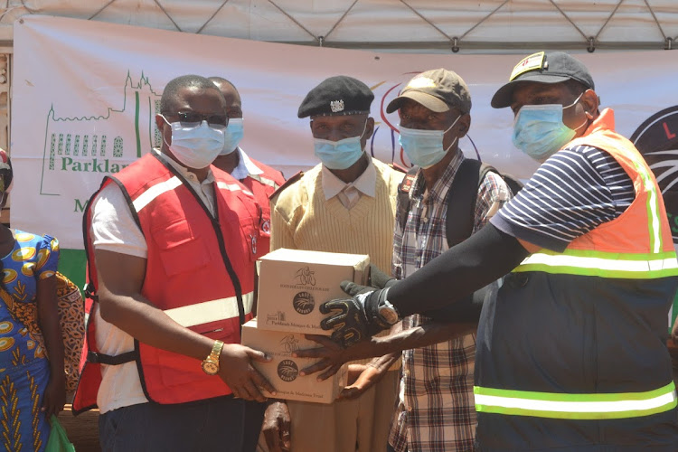 Kenya Red Cross Society Coast Regional Manager Hassan Musa with officials from the Last Resort organisation in Mlilo, Taita Taveta county.