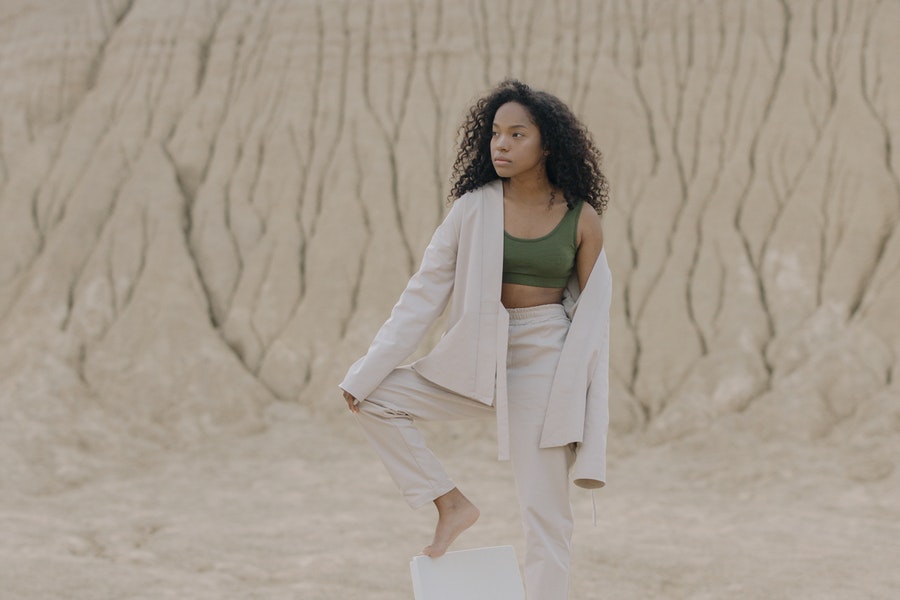 Lady in off white suit piece with green crop top