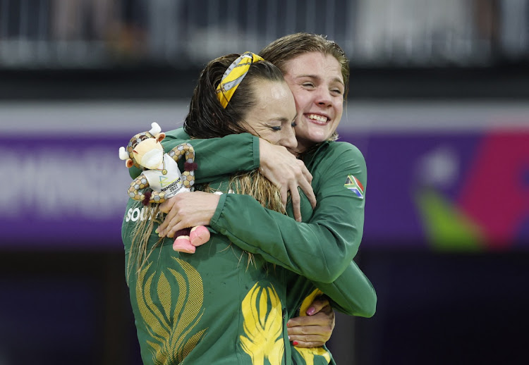 Gold Medallist South Africa's Tatjana Schoenmaker, left, celebrates on the podium alongside bronze medallist and compatriot Kaylene Corbett during the medal ceremony for the women's 200m breaststroke at Sandwell Aquatics Centre, Birmingham on July 31, 2022.