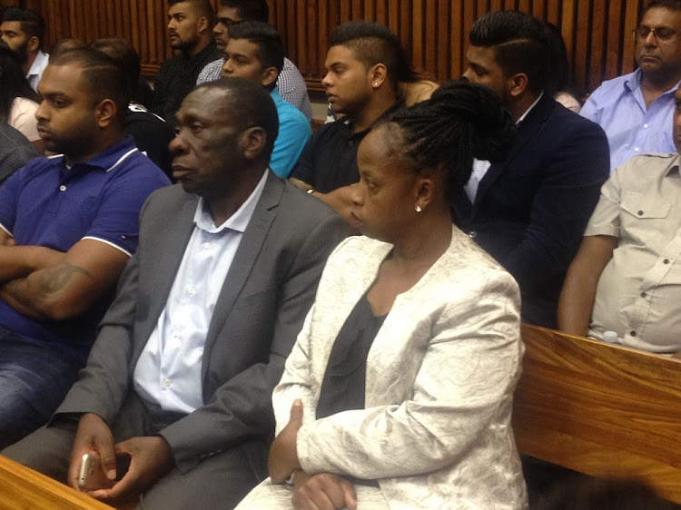 Simba Mhere's parents Angela and Joseph seated next to family members and friends of Preshalin Naidoo,the man accused of causing Simba's death.