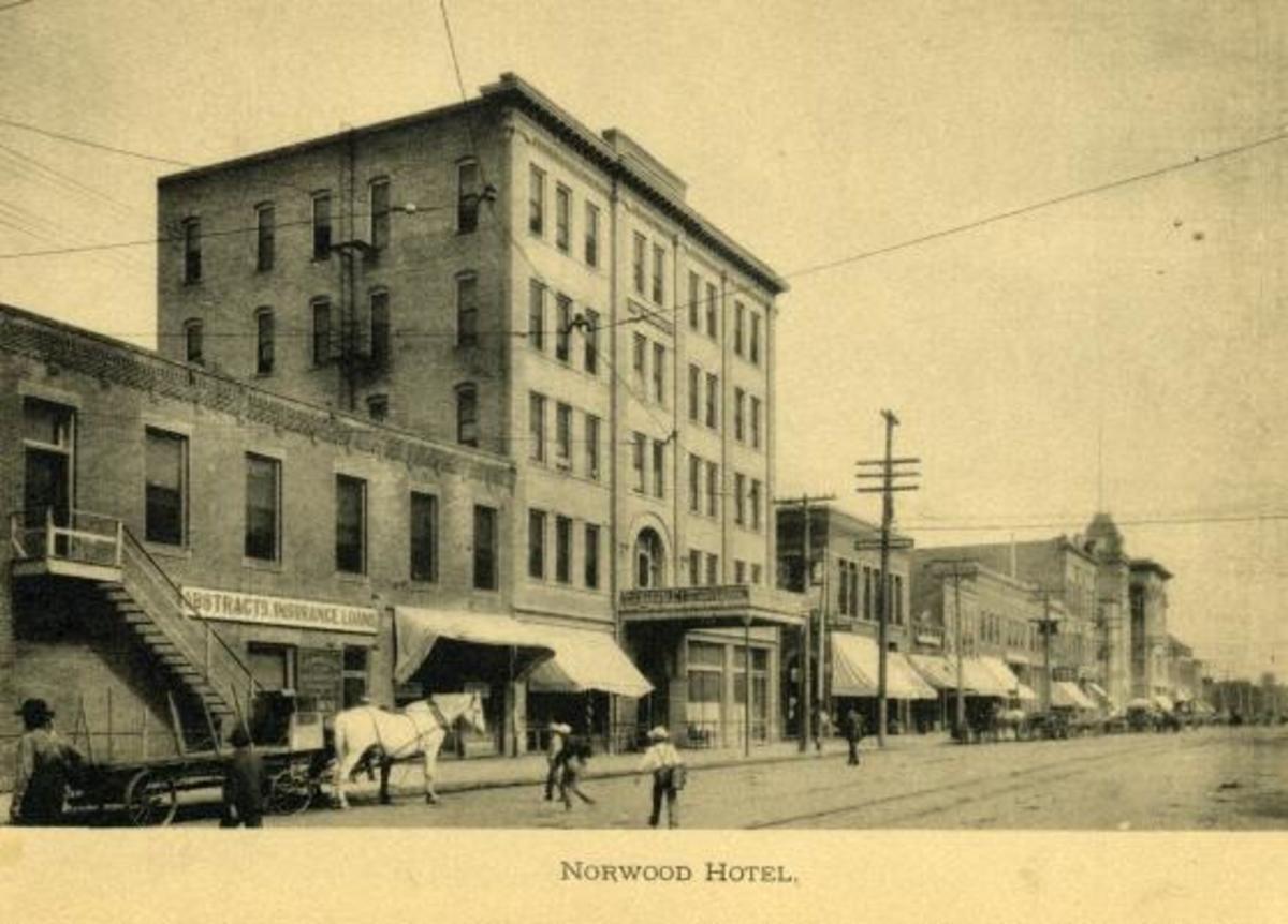 A horse and carriage in front of a buildingDescription automatically generated with low confidence