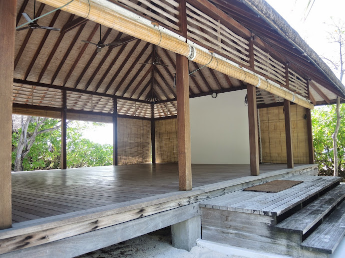 a wooden structure with a roof and stairs