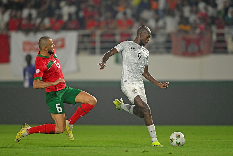 Bafana Bafana striker Evidence Makgopa, right, shoots and scores as he is challenged by Ghanem Romain Saiss of Morocco in their Africa Cup of Nations last 16 clash at Stade Laurent Pokou in San Pedro, Ivory Coast, on Tuesday.