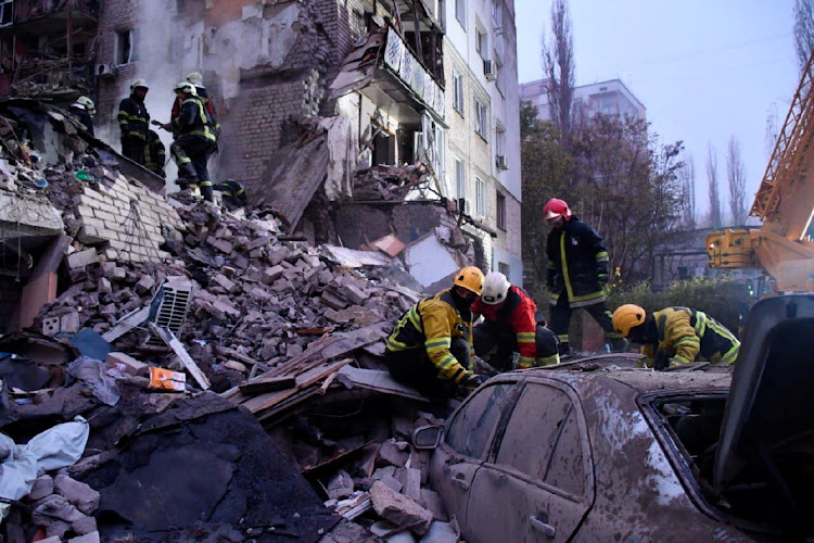 Rescuers work at a site of a residential building heavily damaged by a Russian missile attack, as Russia's attack on Ukraine continues, in Mykolaiv, Ukraine November 11, 2022.