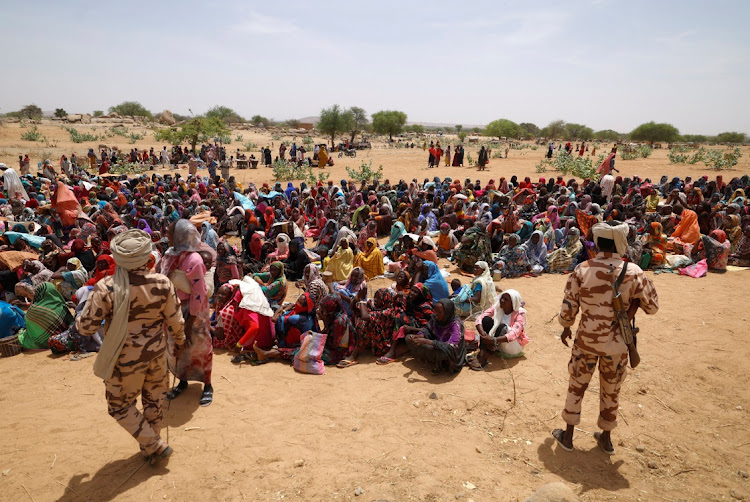 Sudanese refugees, who have fled the violence in their country, wait to receive food rations from World Food Programme (WFP), near the border between Sudan and Chad in Koufroun, Chad May 9, 2023.