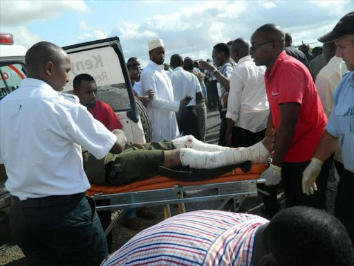One of the Garissa University terror attack victims being helped into an aircraft at Garissa Airstrip, April 1, 2015. /FILE