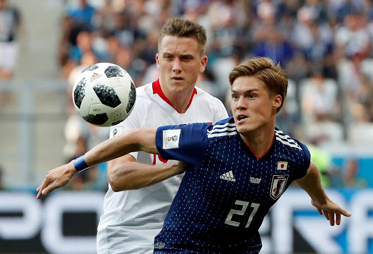 Japan's Gotoku Sakai in action with Poland's Piotr Zielinski in 2018 World Cup