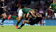 The Springboks' Andre Esterhuizen of South Africa is tackled by Richie Mo’unga of the All Blacks in their Rugby World Cup warmup Test at Twickenham in London Stadium on August 25 2023.