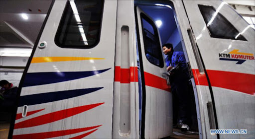 A technician debugs an electric multiple units in China South Locomotive and Rolling Stock Corporation Ltd. (CSR) Zhuzhou Electric Locomotive Co. File photo.