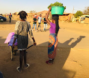 Clara and her sister Sandra have been going door-to-door with their wheelbarrow of fruit and vegetables to sell in an informal settlement in Langaville near Tsakane to help their mother make ends meet. 