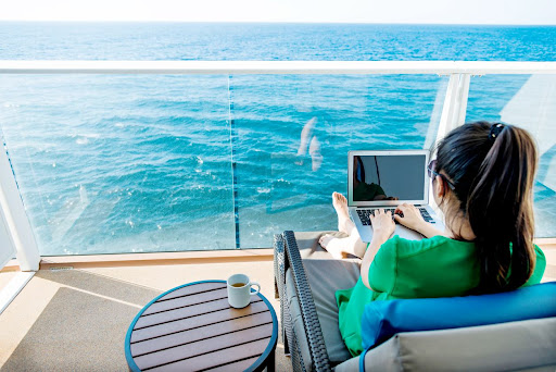 Woman working on her laptop on a cruise ship