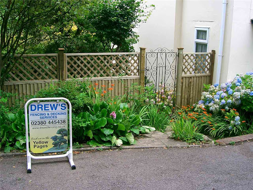 Closeboard panel with trellis above on timber posts