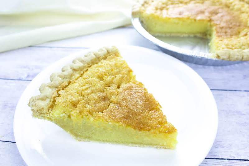 A Slice Of Deep Dish Buttermilk Chess Pie On A Plate.