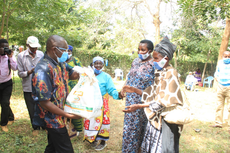 Mwingi north Mp, Paul Nzengu giving women artists food in Mwingi