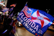 Supporters of US President Donald Trump wave flags during the 2020 presidential election in Little Havana, Florida.