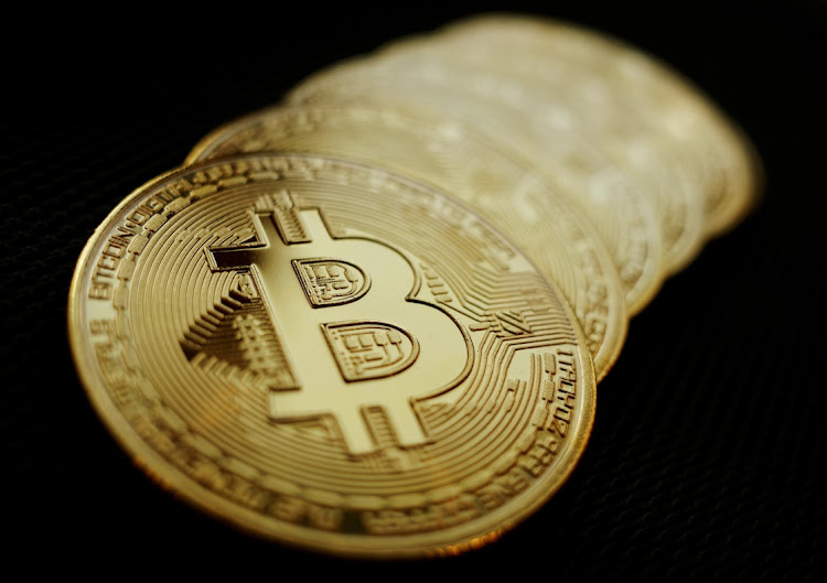 Representations of the Bitcoin cryptocurrency are seen in this illustration picture. File photo: REUTERS/EDGAR SU