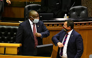 President Cyril Ramaphosa greets DA leader John Steenhuisen before his address to a joint sitting of parliament on Thursday.