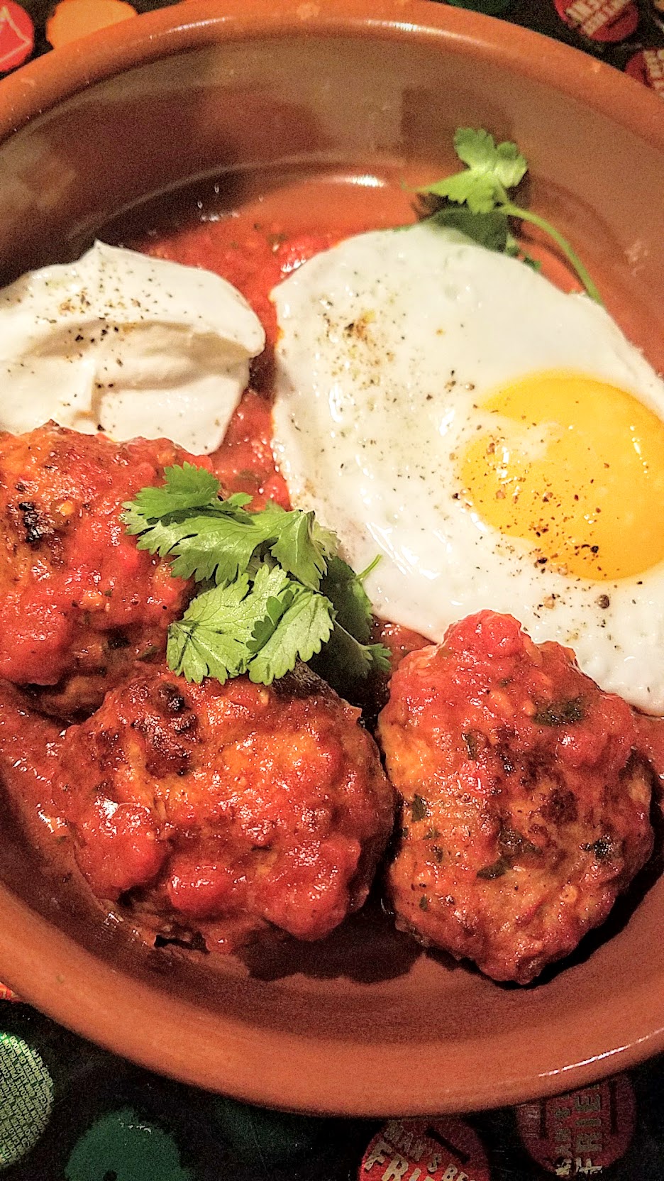 Example Food at Saraveza lamb meatballs with tomato sauce, yogurt, and sunny egg