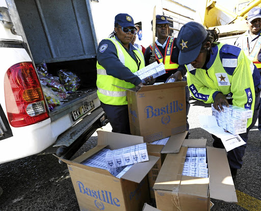 Police confiscate illegal tobacco on the N2 at Kinkelbos, Port Elizabeth, from a courier van at a roadblock in this file photo.