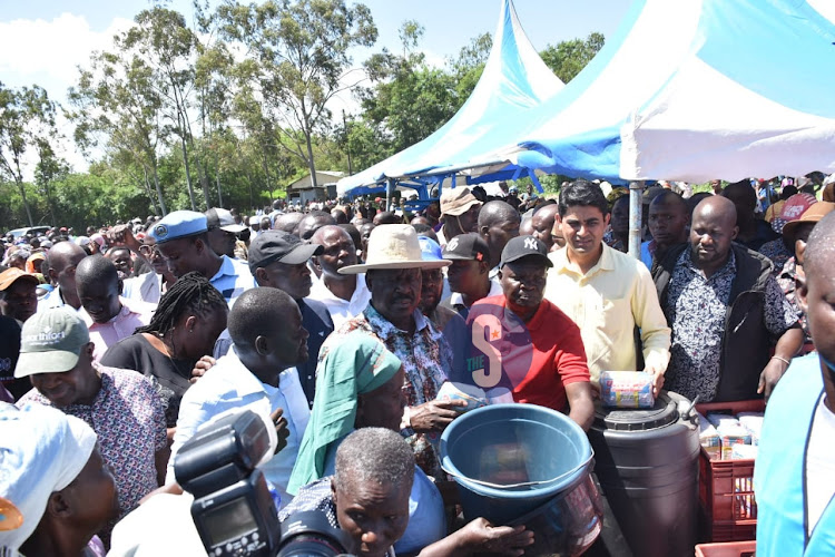 Raila Odinga at Migingo evacuation center in Nyando giving relief food to flood victims on May 11, 2023.