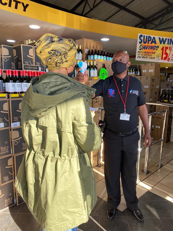 Shoppers queue at a Joburg liquor store.