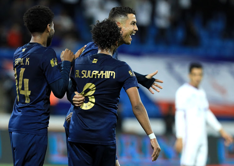 Abdulmajeed Al Sulayhim (foreground) celebrates with Cristiano Ronaldo and other teammates after scoring Al-Nassr's fifth goal in their Saudi Pro League win against Abha Club at Prince Sultan bin Abdulaziz Sports City in Abha, Saudi Arabia on Tuesday night.