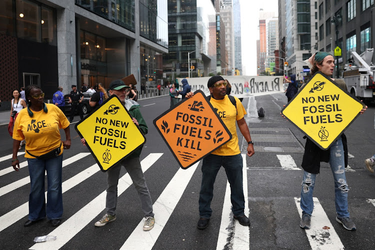 Climate activists block vehicle traffic during a protest outside the headquarters of Blackrock in Manhattan in New York City, New York, US, September 13, 2023.