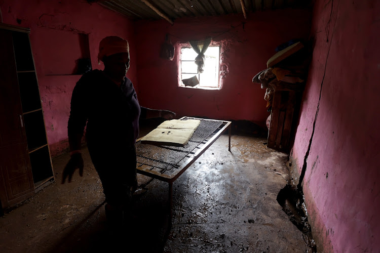 A Peace Valley resident clears her house after flooding.