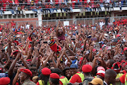 EFF supporters cheer Julius Malema as he arrives at a party rally in Chatsworth on Sunday.