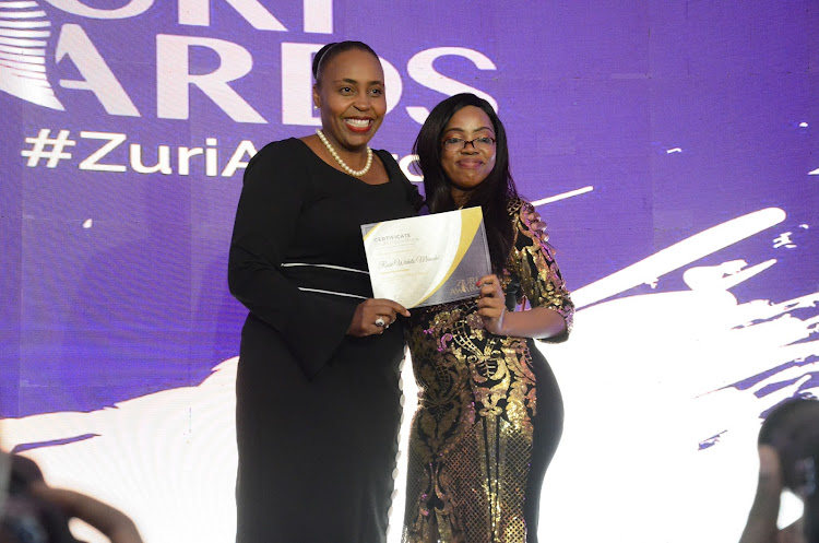 Jackline Obago receives the Innovation category award from Nyeri Deputy Governor Caroline Karugu