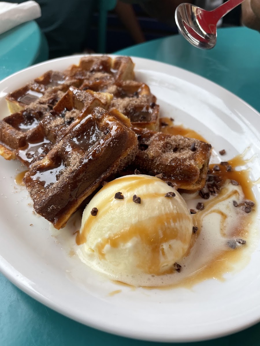 Waffle churros with cinnamon and brown sugar, caramel chocolated drizzle and vanilla ice cream