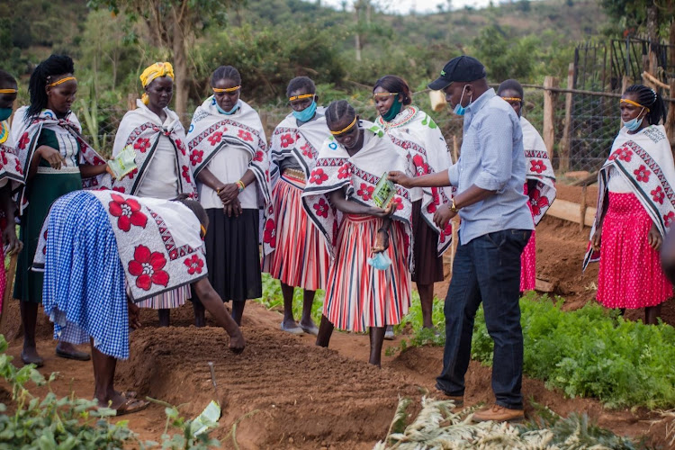 Ministry of Agriculture technical officer demonstrating how to prepare a plant nursery in April to Members of the Cheptuyis Mother to Mother Support Group in Pokot South in West Pokot County in April 2021.