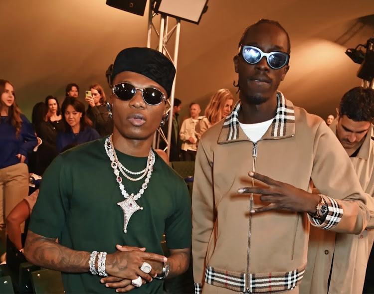 Wizkid and Unknown T attend the Burberry Spring Summer 2024 show during London Fashion Week on September 18, 2023 in London, England.