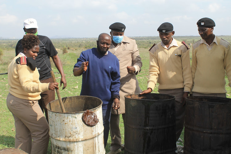 Athi River chief Cecilia Nziyoka, Empakas assistant chief Nickson Paramisa, his Athi River Township counterpart Martin Ngomo and Oloshaiki's David Kirayian confscicating chang'aa at County village in Athi River sub county on February 12.