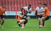 Wandisile Simelane of the Lions is tackled by James Lang of Edinburgh during their Vodacom United Rugby Championship match at Ellis Park. 