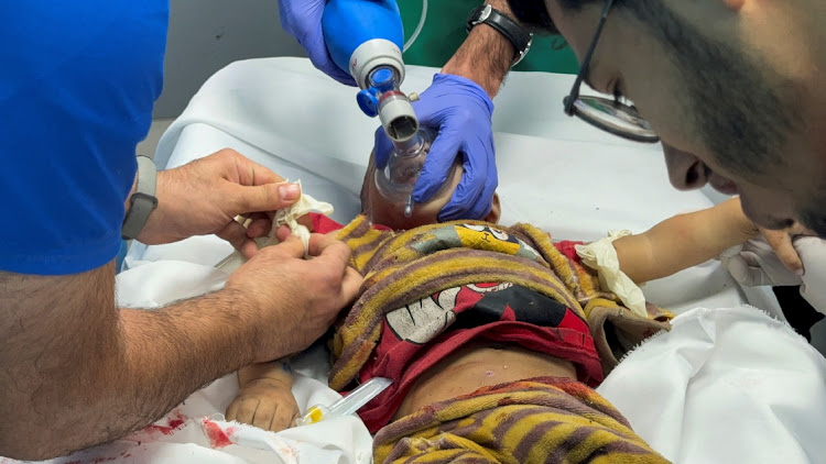 Medical professionals treat a Palestinian child wounded in Israeli strikes at Nasser hospital, amid the ongoing conflict between Israel and Palestinian Islamist group Hamas, in Khan Younis, in the southern Gaza Strip on December 15 2023. Picture: REUTERS/Bassam Masoud