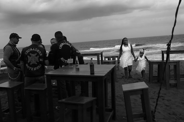 Members of the Bandits chat on the beach during their National Run to Durban.