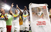 Senegal's players celebrate with the crowd after defeating Ecuador 2-1 in their final Group A game and qualifying to the next round of the Qatar 2022 World Cup at Khalifa International Stadium in Doha on November 29 2022.