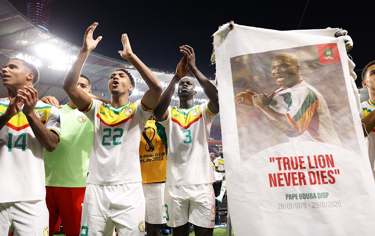 Senegal's players celebrate with the crowd after defeating Ecuador 2-1 in their final Group A game and qualifying to the next round of the Qatar 2022 World Cup at Khalifa International Stadium in Doha on November 29 2022.