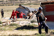 Members of the Red Ants demolish a shack in Dunoon, Cape Town, on April 25 2019.