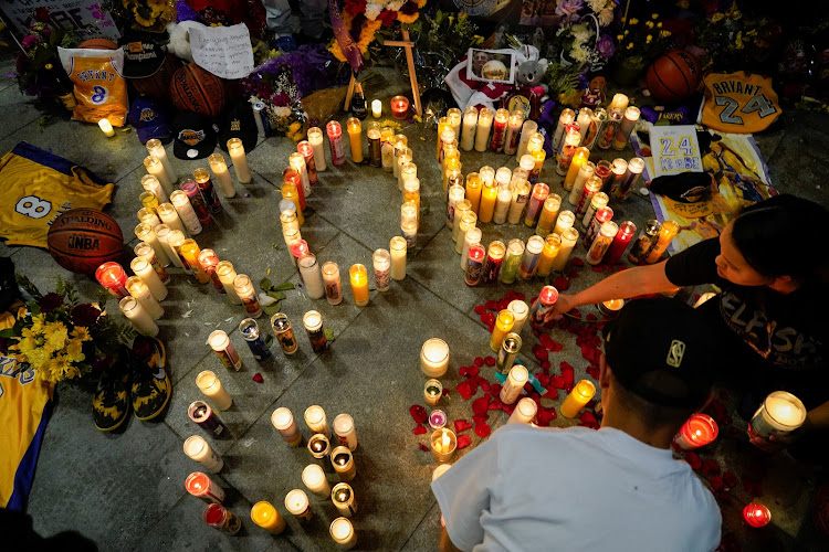 Mourners gather in Microsoft Square near the Staples Center to pay respects to Kobe Bryant after a helicopter crash killed the retired basketball star, in Los Angeles