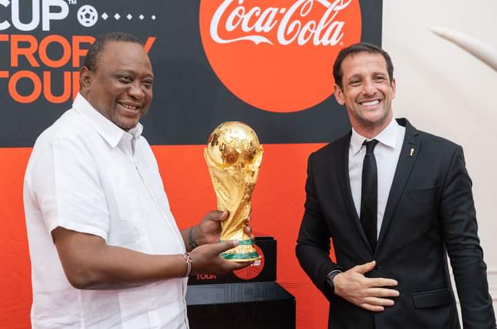 President Uhuru Kenyatta with Brazilian star Juliano Belletti with the FIFA World cup trophy at State House on Thursday, May 26, 2022.