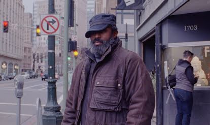 A man on a busy street who has shared details about his relationship to technology.