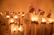 Christian faithful of the Legio Maria African Mission church attend the Christmas eve vigil mass amid the coronavirus disease (COVID-19) pandemic at their church in the Fort Jesus area of Nairobi, Kenya, December 25, 2021. 